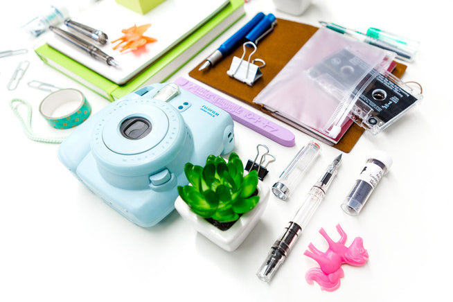 Assorted fountain pens and other desk items