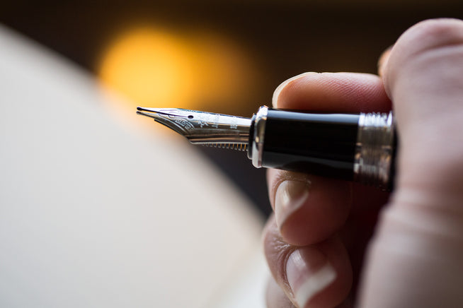 Close up of fountain pen tines splayed