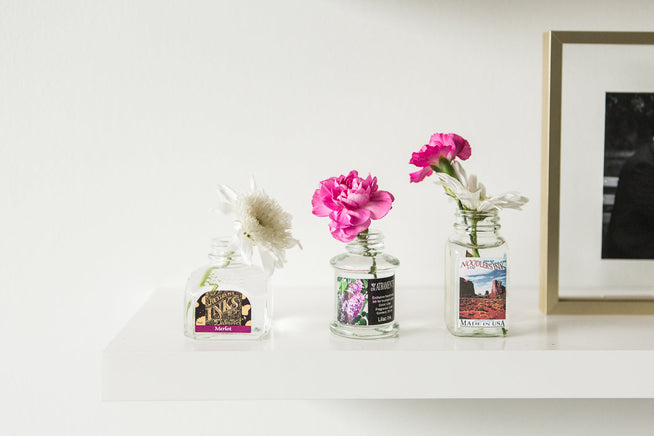 Empty fountain pen bottles being used as bud vases