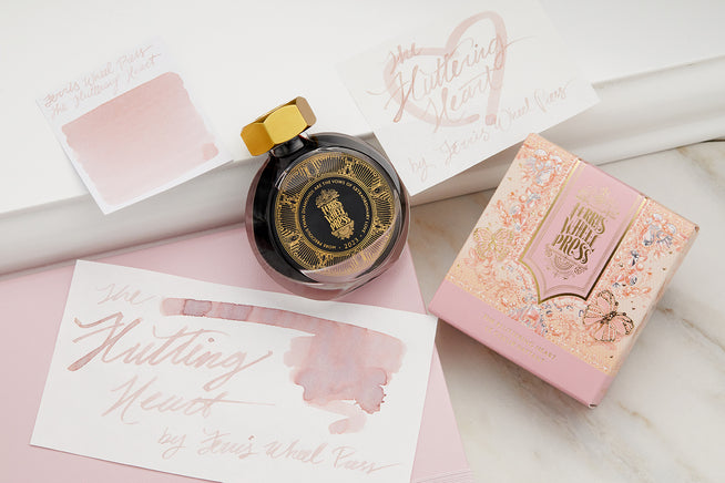 Ferris Wheel Press The Fluttering Heart Ink bottle and swab, with writing sample on pale pink and white background.