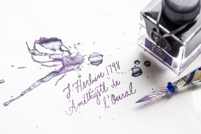 Jacques Herbin fountain pen ink bottle with glass dip pen and writing sample