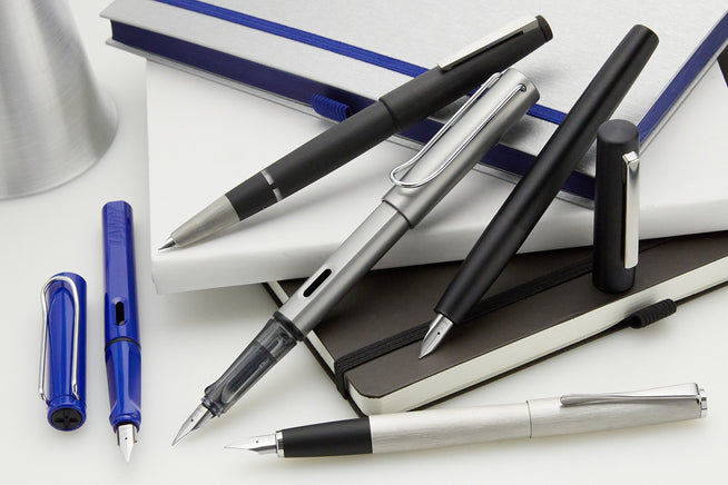 assorted LAMY safari fountain pens on a desk