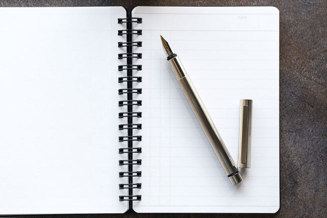 LAMY cp1 uncapped on a lined notebook 