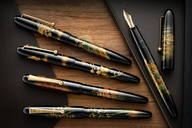 Namiki Maki-e Fountain Pens capped on a wooden box 