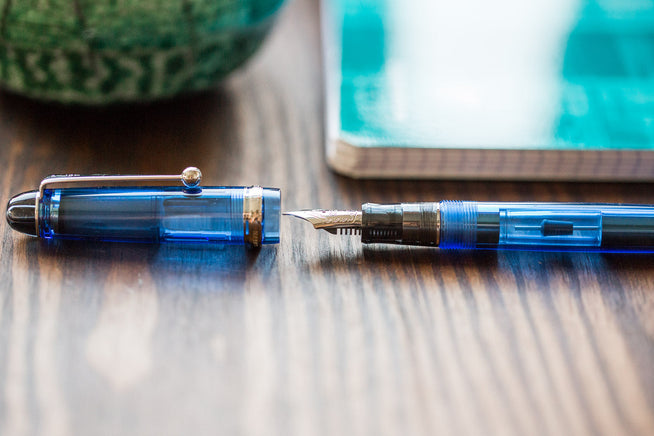 Blue Pilot Custom 74 uncapped on wooden desk