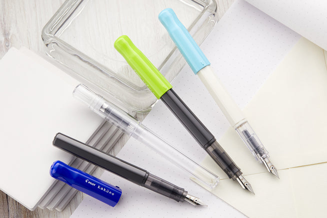 Pilot Kakuno assorted fountain pens on white notebooks
