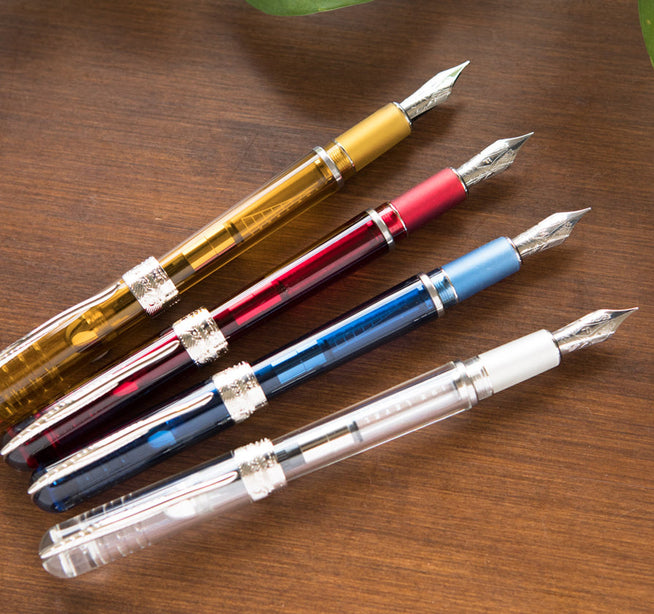 Pineider Avatar Demonstrator Fountain Pens uncapped on desk