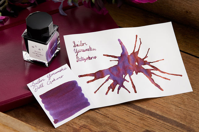 Sailor Yurameku Data Gokoro Ink writing sample, bottle and swab on desk background