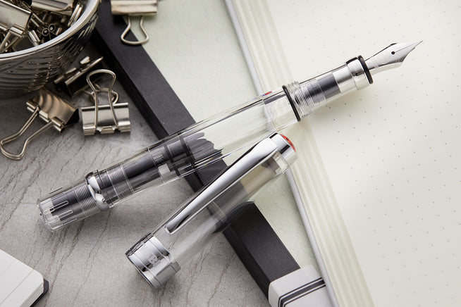 TWSBI 580 fountain pen clear on light green notebook