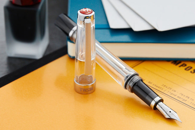 TWSBI VAC-700R clear on yellow notebook