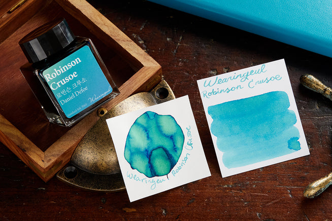 Wearingeul Robinson Crusoe ink bottle and ink splatter on nautical themed background