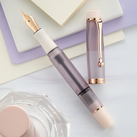 Two Opus 88 Harmony fountain pens with pastel bodies and rose gold trim