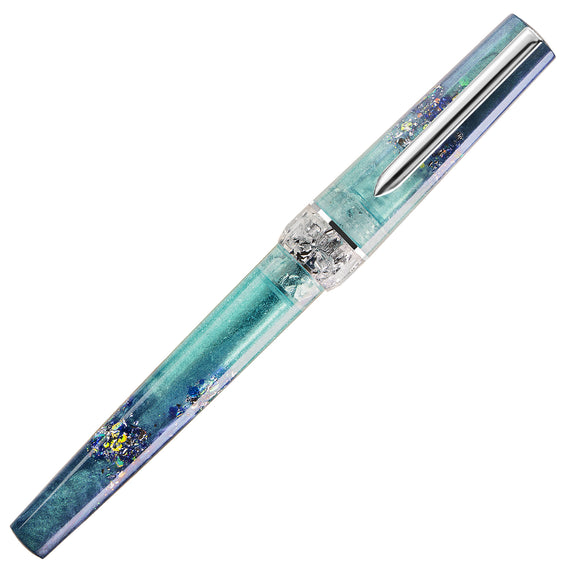 A decorative ballpoint pen with a translucent teal and blue body containing embedded gold foil flakes, a silver clip, and a textured clear band in the center, shown on a plain white background.