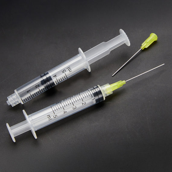 Two syringes used to flush ink from fountain pens.